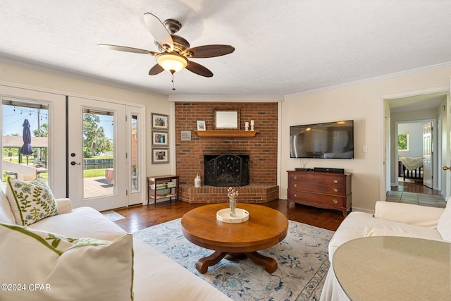 living room featuring a fireplace, a textured ceiling, and dark wood-type flooring