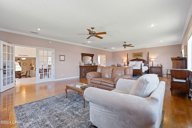 living room with french doors, ornamental molding, wood-type flooring, and ceiling fan