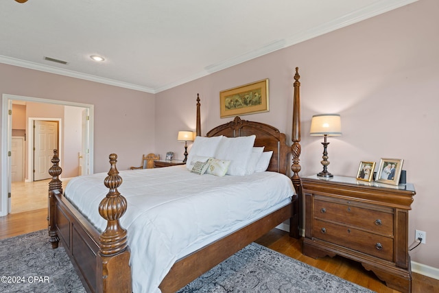 bedroom featuring dark wood-type flooring and crown molding