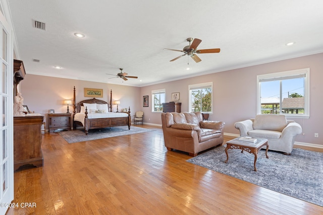 bedroom with crown molding and light hardwood / wood-style flooring