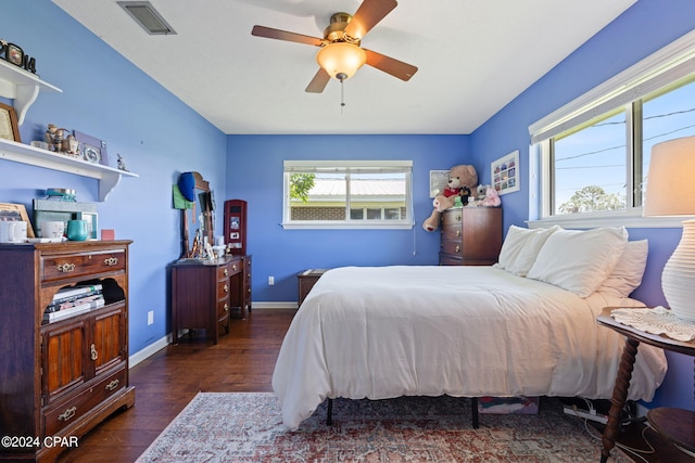 bedroom with dark hardwood / wood-style flooring and ceiling fan