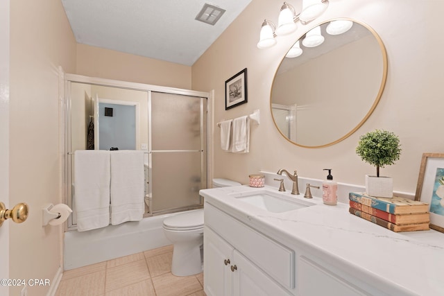 full bathroom with combined bath / shower with glass door, tile flooring, oversized vanity, and toilet