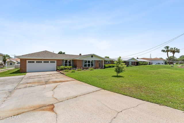 single story home featuring a garage and a front yard