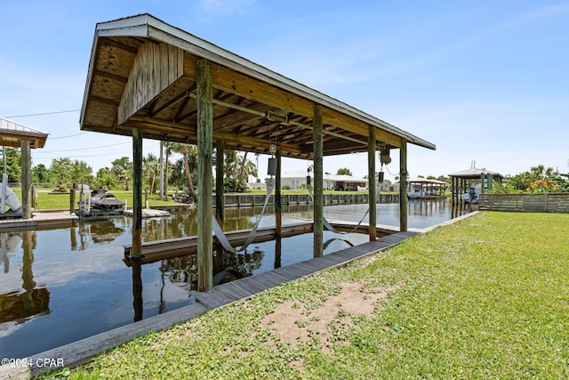 dock area with a water view and a yard