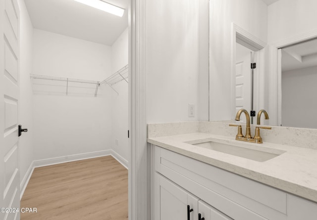 bathroom with vanity and hardwood / wood-style floors