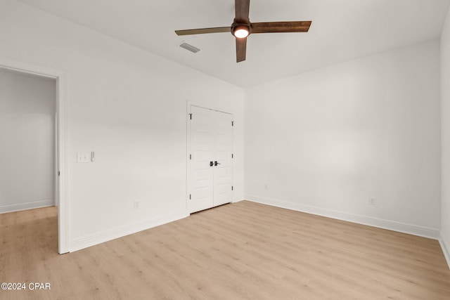 unfurnished bedroom featuring ceiling fan, a closet, and light hardwood / wood-style floors