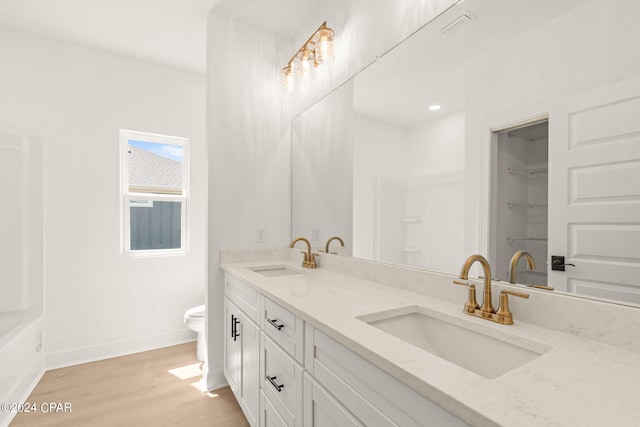 full bathroom featuring shower with separate bathtub, wood-type flooring, vanity, and toilet