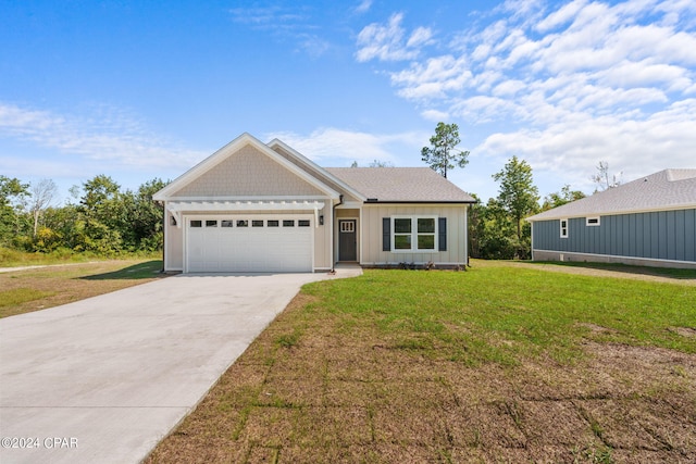 view of front facade featuring a front yard and a garage