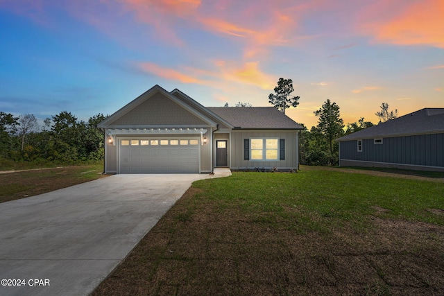 view of front of home featuring a yard and a garage