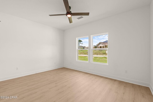 spare room with light hardwood / wood-style flooring and ceiling fan