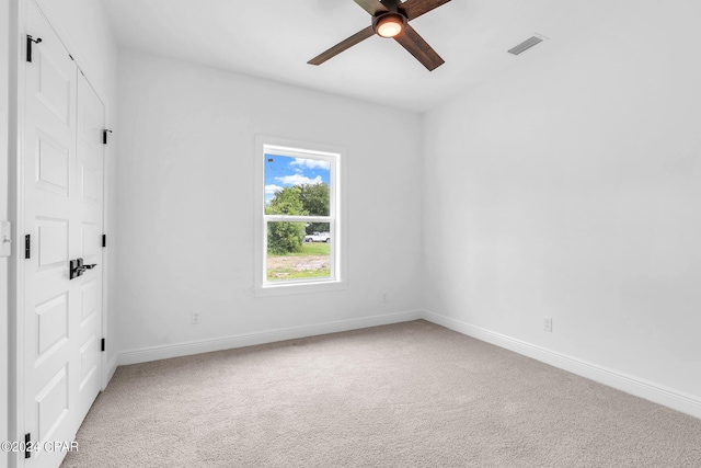 spare room featuring carpet and ceiling fan