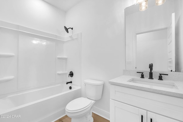 full bathroom featuring hardwood / wood-style floors, vanity, toilet, and tub / shower combination