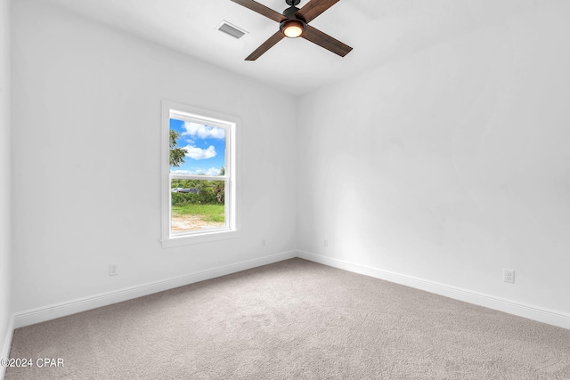 carpeted spare room with ceiling fan