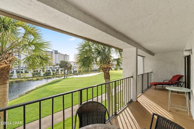 balcony featuring a water view