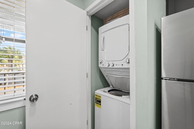 laundry area with stacked washing maching and dryer