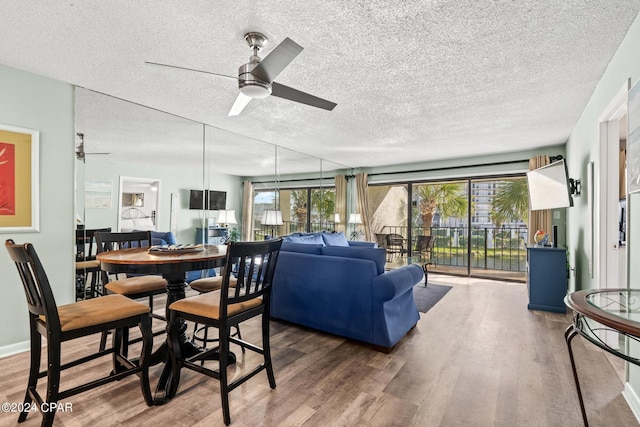 interior space with ceiling fan, wood-type flooring, and a textured ceiling