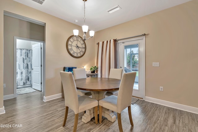 dining room featuring a chandelier and wood-type flooring