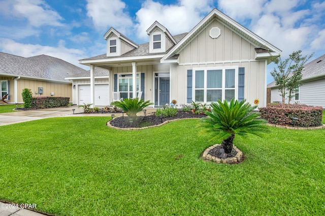 view of front of home with a front yard and a garage