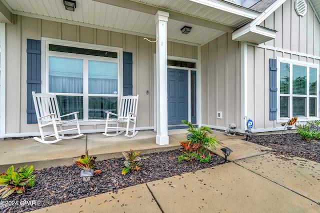 view of exterior entry with a porch