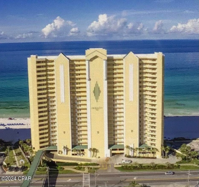 exterior space featuring a beach view and a water view