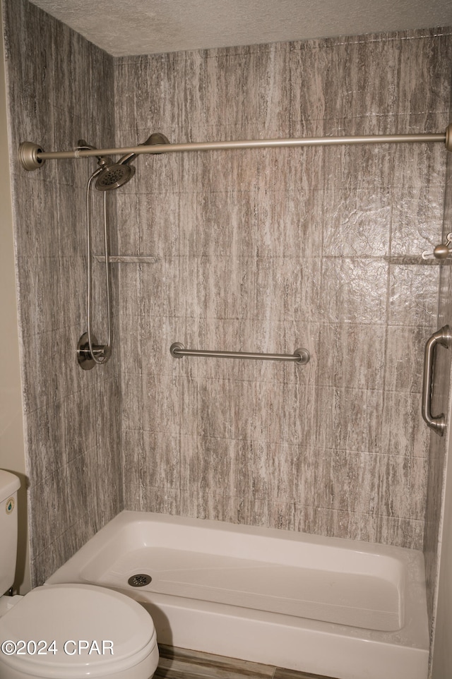 bathroom featuring toilet and a textured ceiling