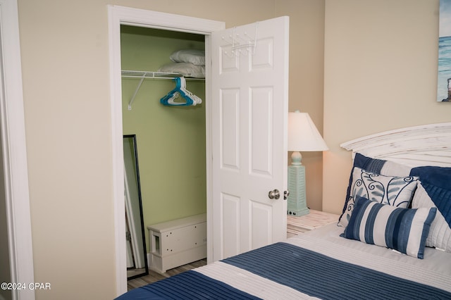 bedroom with a closet and hardwood / wood-style floors