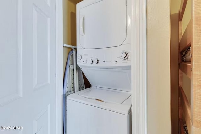 laundry area featuring stacked washing maching and dryer