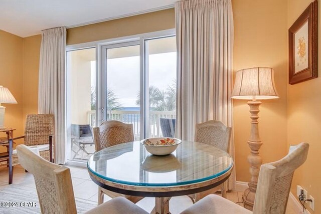 tiled dining space featuring plenty of natural light