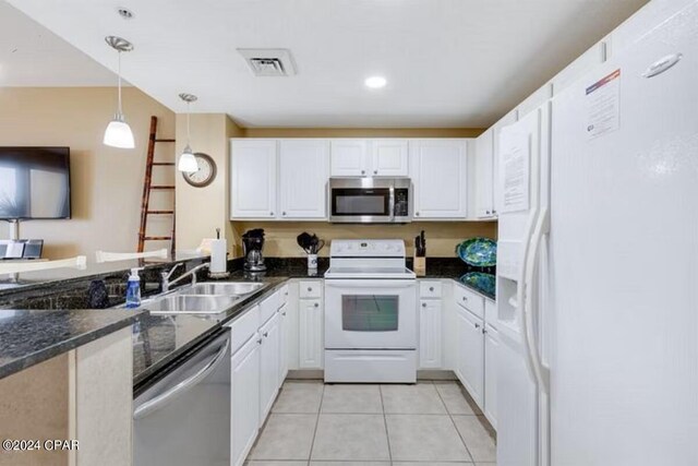 kitchen with stainless steel appliances, white cabinetry, hanging light fixtures, and sink