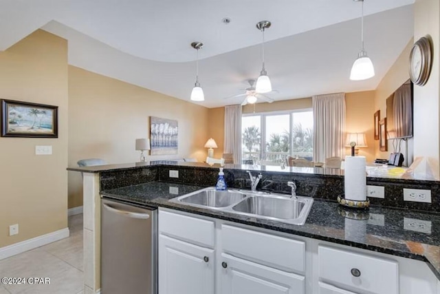 kitchen with dishwasher, pendant lighting, sink, and white cabinets