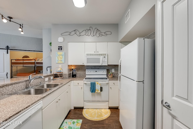 kitchen featuring dark hardwood / wood-style floors, sink, white cabinets, and white appliances