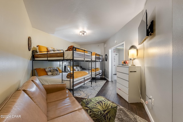 bedroom with dark wood-type flooring