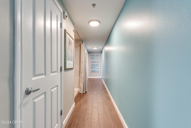 hallway with wood-type flooring