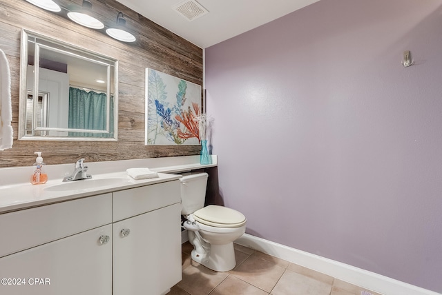 bathroom with tile flooring, oversized vanity, and toilet