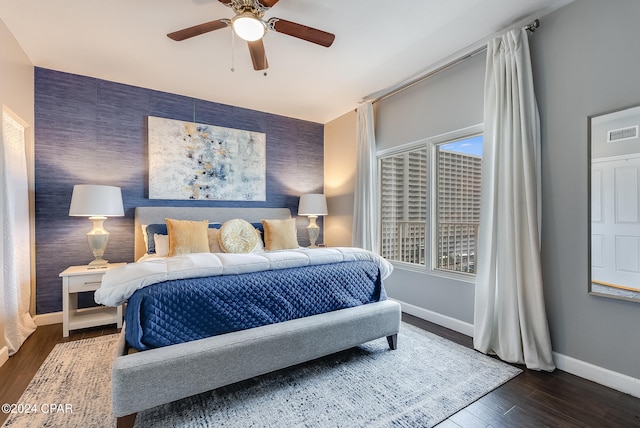 bedroom featuring ceiling fan and dark hardwood / wood-style flooring