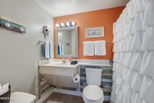 bathroom featuring tile floors, toilet, and vanity