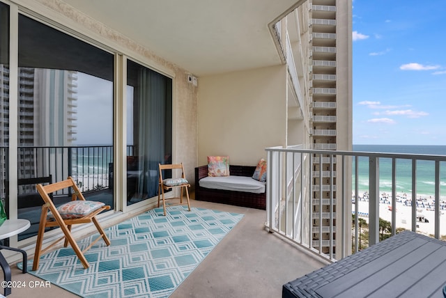 balcony featuring a beach view and a water view