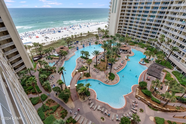 drone / aerial view featuring a beach view and a water view