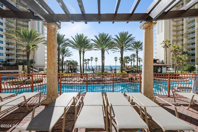 view of swimming pool featuring a pergola and a water view