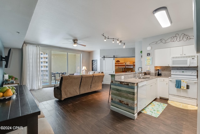 kitchen with white appliances, white cabinets, track lighting, and dark wood-type flooring