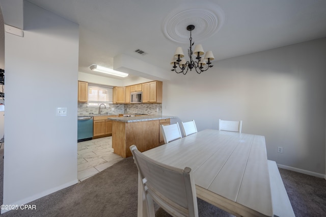 dining area with light colored carpet, an inviting chandelier, and sink