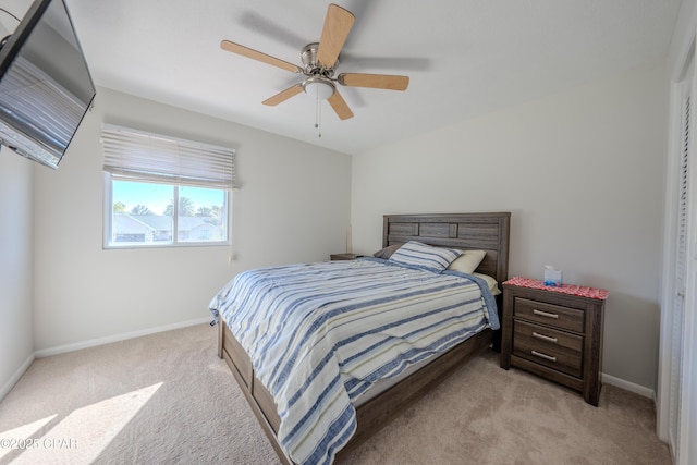 bedroom featuring light colored carpet and ceiling fan