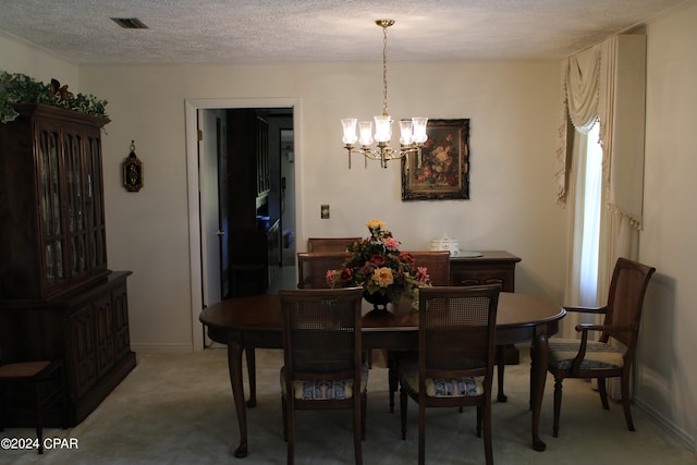 carpeted dining room with an inviting chandelier and a textured ceiling