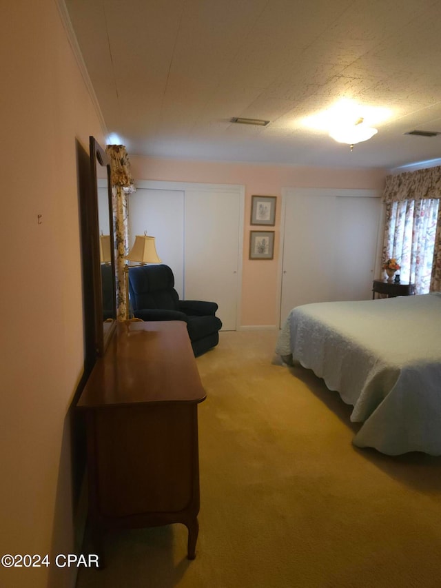 bedroom featuring ornamental molding and carpet floors