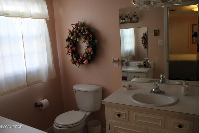 bathroom with vanity, plenty of natural light, and toilet