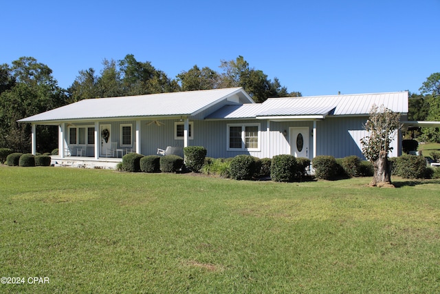 single story home featuring a porch and a front yard