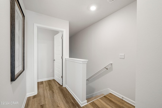 hallway with hardwood / wood-style floors