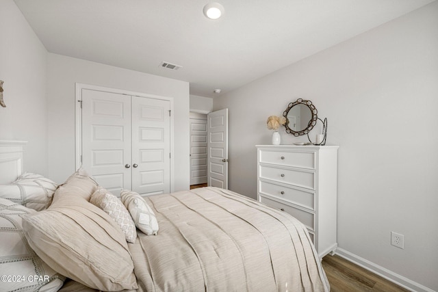 bedroom featuring a closet and dark hardwood / wood-style flooring