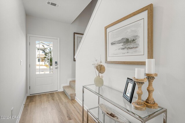 stairway with wood-type flooring and ceiling fan