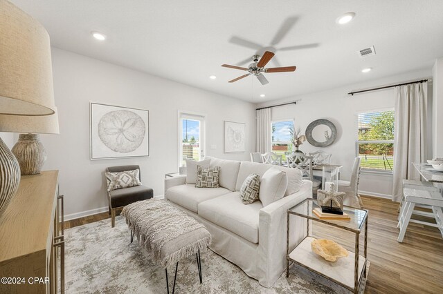 dining room with ceiling fan and light hardwood / wood-style flooring